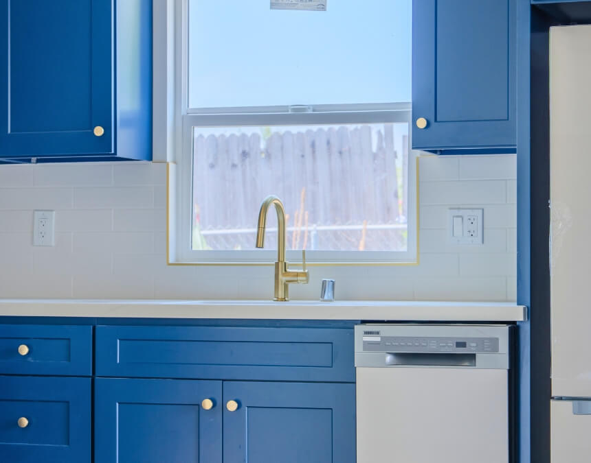 Modern ADU kitchen with blue cabinets and natural light