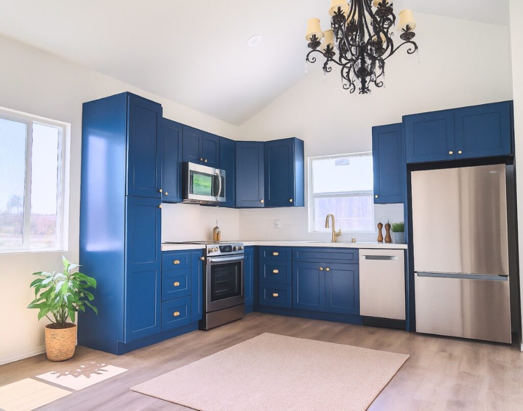 On-site oversight & quality control displaying vibrant navy kitchen cabinets with brass accents.