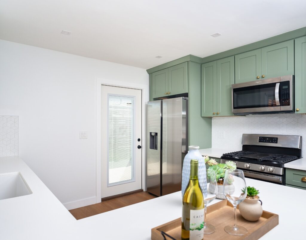 Pacific Beach Modern Luxe 1 showcasing sage-green shaker cabinetry and bright kitchen finishes.