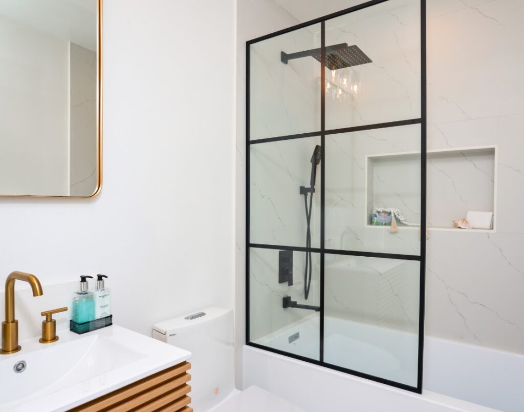 Pacific Beach Modern Luxe 2 highlighting luxury bathroom with matte black fixtures and elegant shower niche.