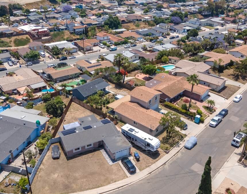 Aerial view of a residential San Diego neighborhood with detached homes, RVs, and large backyards.