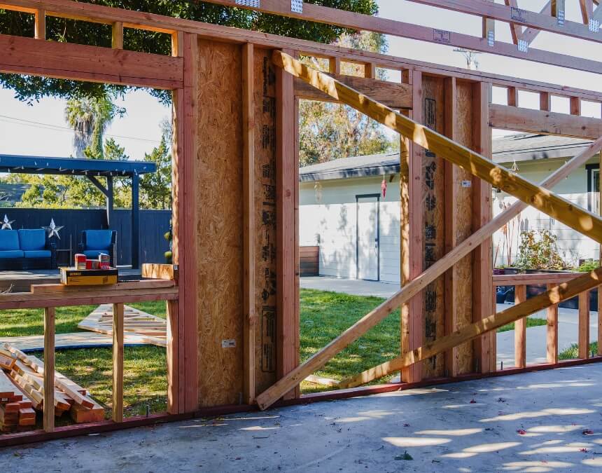 Framing phase of a detached granny flat with contractors on site.