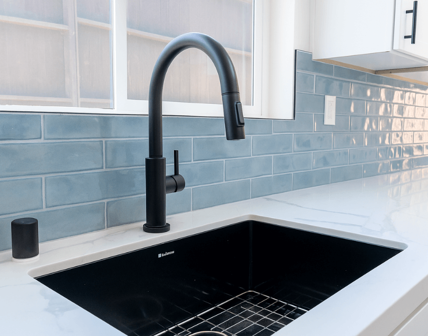 Close-up of a sustainable kitchen with recycled countertop materials, low-VOC finishes, and water-saving matte black faucet.