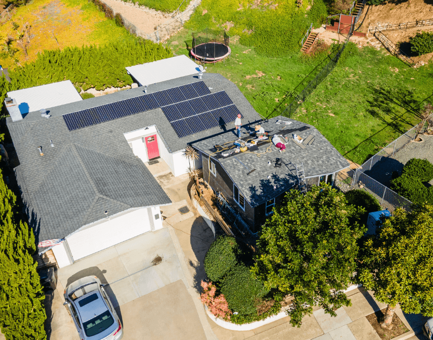 Aerial view of a residential property with solar panels on the ADU roof, highlighting integrated renewable energy and water conservation systems.