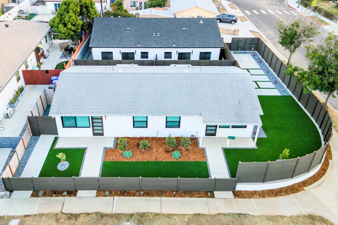 Aerial view of two detached ADUs with modern fencing and landscaped yards