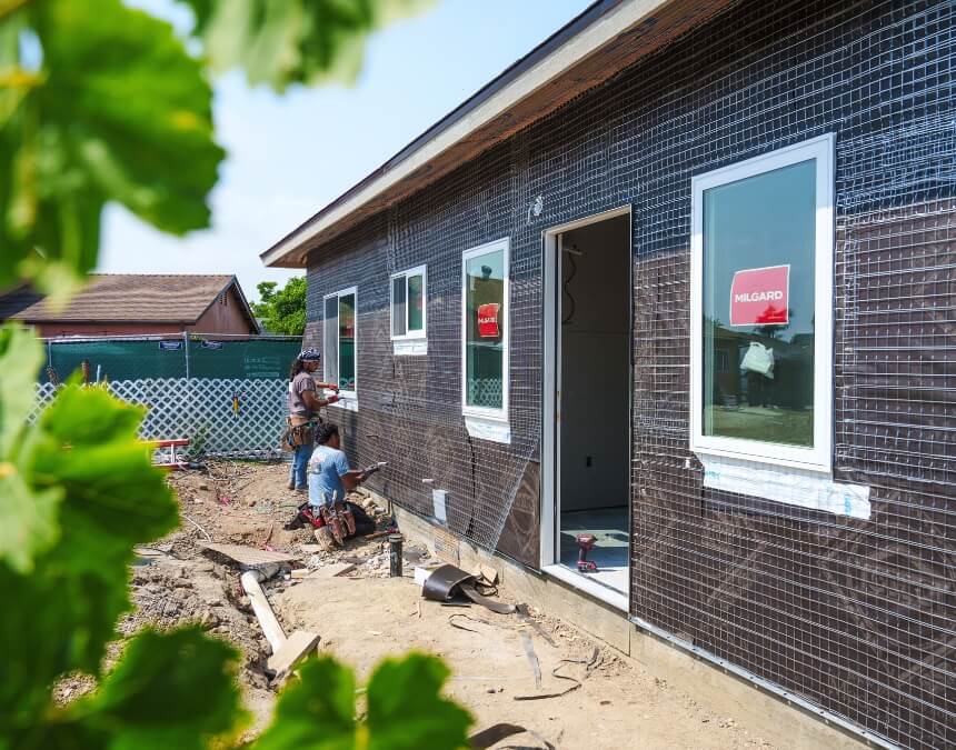 Consequences of Not Sending the Preliminary Notice with workers installing exterior siding on a new build