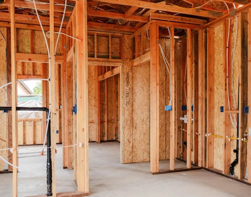 Hidden Costs and Overpromising – interior ADU framing with visible plumbing and electrical rough-ins.