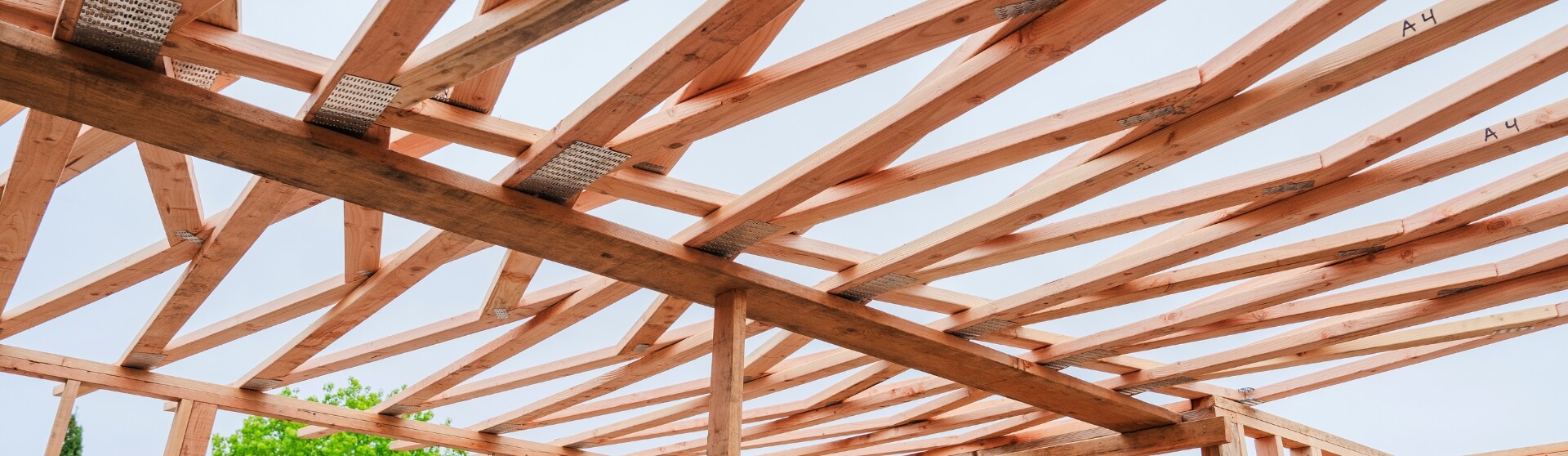 How Do You Compare ADU Builder Quotes in San Diego and California – wide-angle view of wood truss roof framing.