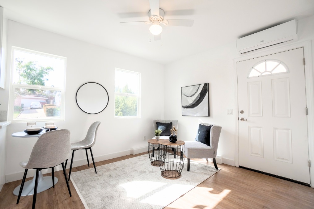 Compact ADU living room with round dining table, modern chairs, and bright natural light