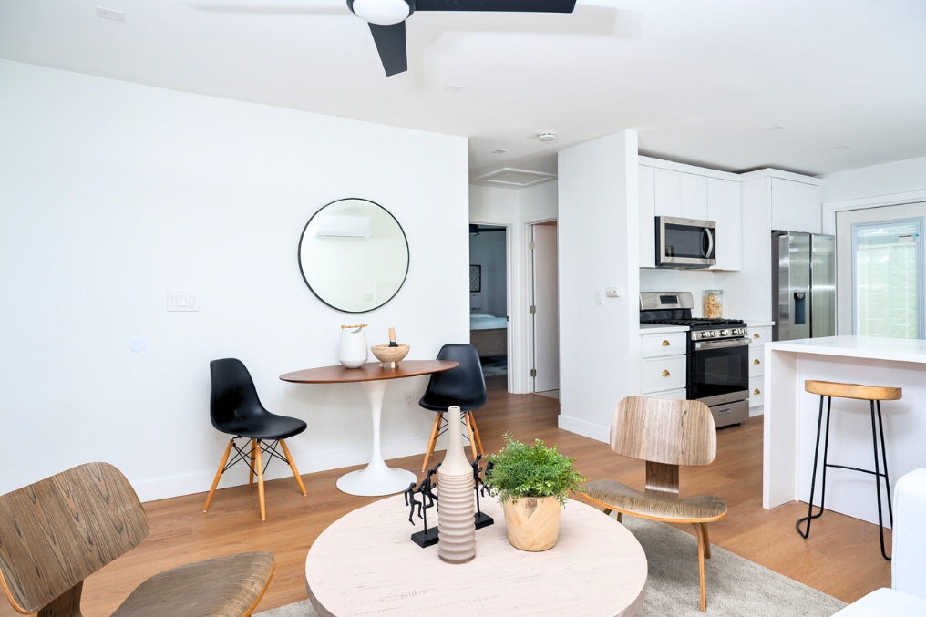 ADU great room with round dining table, modern chairs, and full kitchen view
