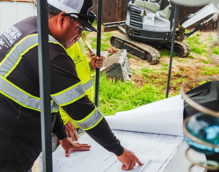 The Role of Professionals – Civil engineers reviewing site plans during ADU construction.