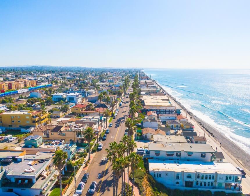 Aerial shot of Understanding Coastal Zone Regulations highlighting coastal homes and roads along the bluff.