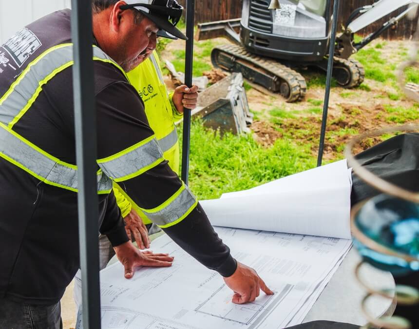 What Types of Builders Provide ADU Quotes – contractors reviewing ADU blueprints at the job site.