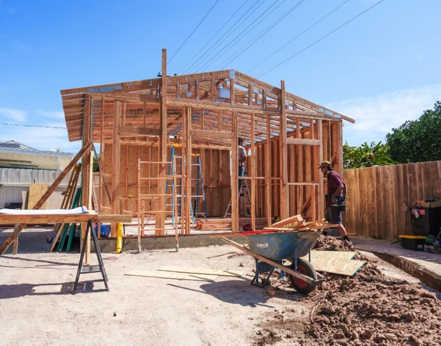 What is an ADU builder quote – framing stage of an ADU build with construction crew on site.