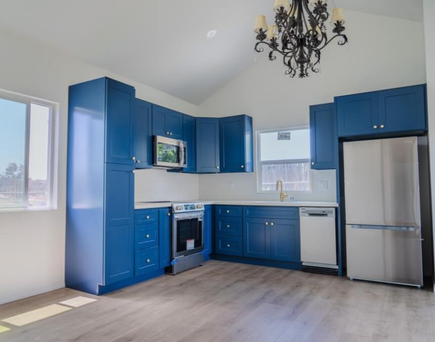 Contemporary ADU kitchen with blue cabinets — Benefits for Homeowners & Investment Potential visual for Better Place Design & Build blog.