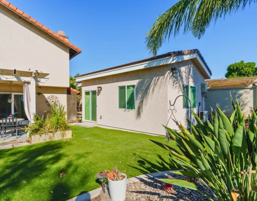 Assessing the Need for a Retaining Wall image showing a completed backyard ADU on a mostly level lawn, illustrating how flat sites often avoid retaining wall requirements.