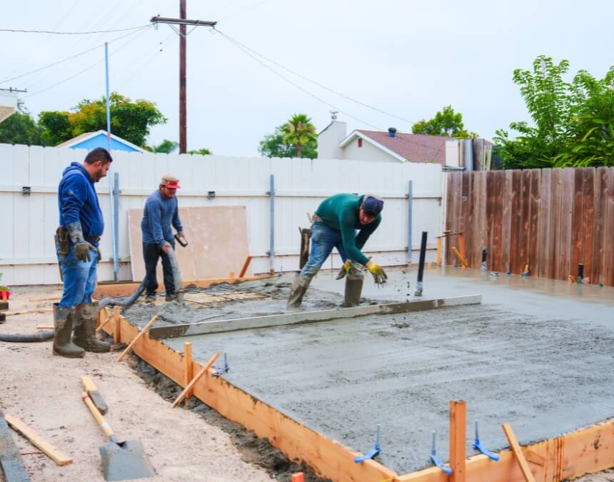 “Conclusion — Choosing a Trustworthy ADU Builder in San Diego” image of workers pouring and finishing a concrete slab for an ADU.