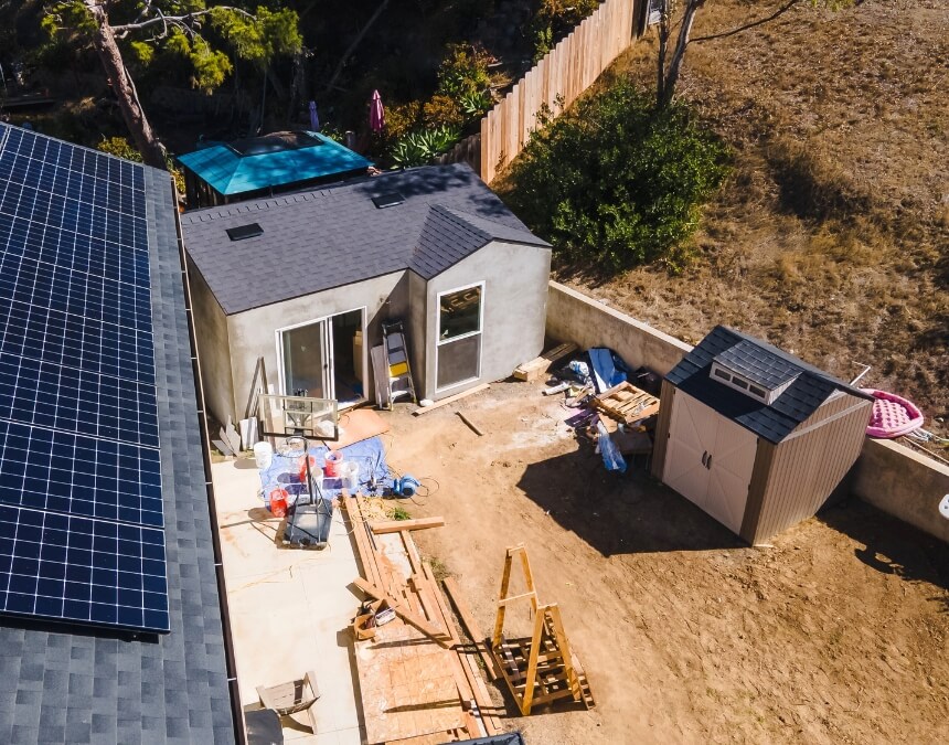 Consulting with Experts image showing an ADU near a slope with construction materials, emphasizing the role of engineers and builders in retaining wall decisions.