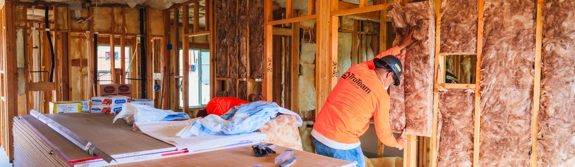 “Do You Trust Your Builder” image showing ADU interior framing with insulation install during construction.
