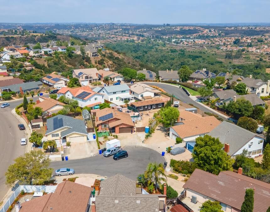 “Importance of Surveys in Compliance & Legal Protection” wide view of homes and hills in San Diego County, emphasizing neighborhood boundary context.