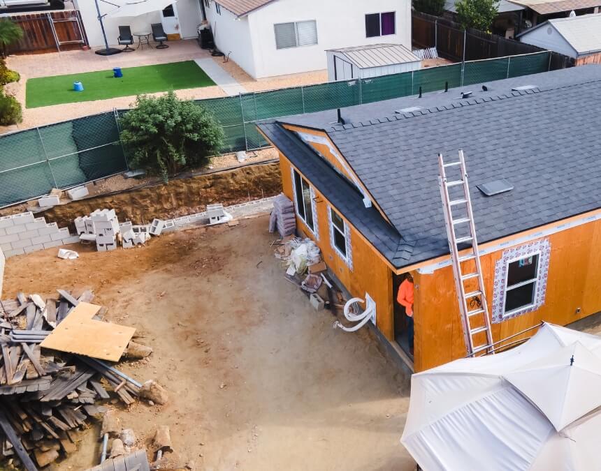 Potential Drawbacks of Retaining Walls – ADU construction site showing limited yard space and materials staged near a sloped lot.