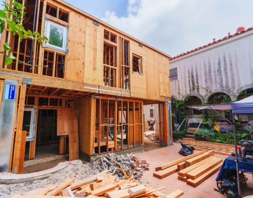 Architectural Designs for Stacked ADUs image showing an in-progress two-story ADU structure illustrating framing considerations for stacked layouts.