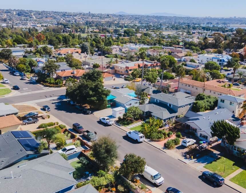 Challenges and Solutions image showing an aerial view of neighborhood housing patterns relevant to stacked ADU zoning and site constraints.