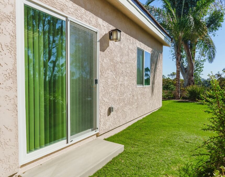 Land and Topography Considerations – ADU exterior on a landscaped lot demonstrating ideal flat grading for simpler foundation work.