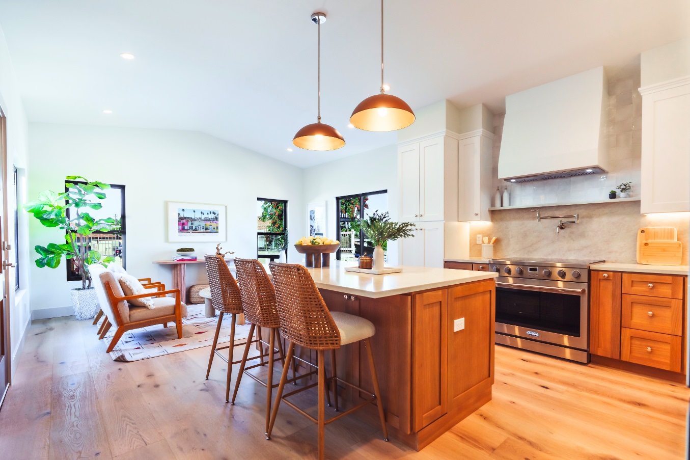 Full kitchen view in the Linda Vista Detached ADU with wood cabinetry, stainless steel appliances, marble-style backsplash, and open shelving.