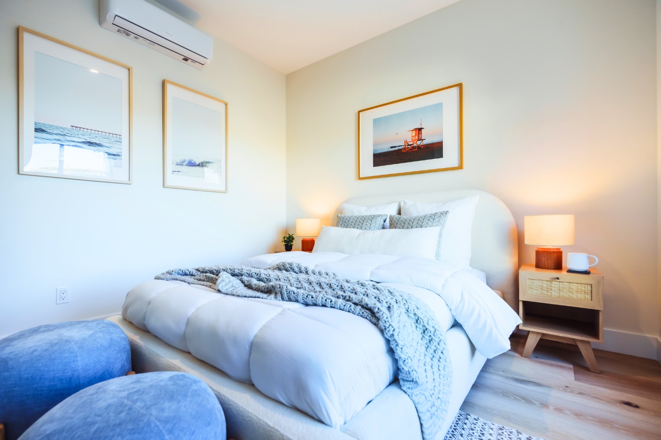 Cozy primary bedroom inside the Linda Vista Detached ADU with soft neutral bedding, framed artwork, natural light, and modern nightstands.