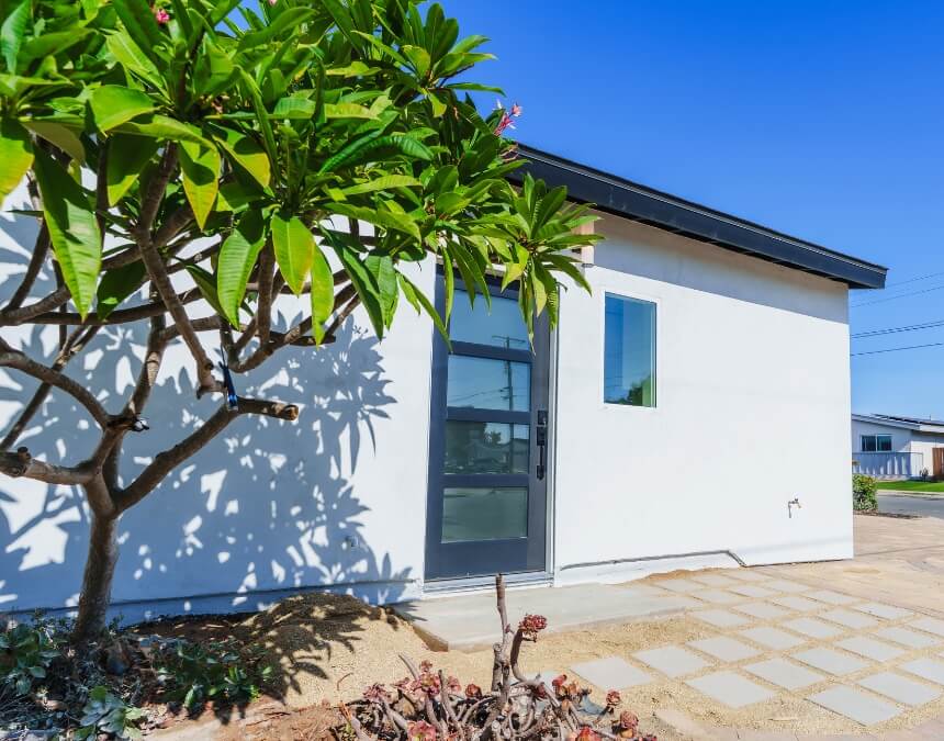 Understanding Accessory Dwelling Units (ADUs) in California showing a residential property with a backyard ADU under construction