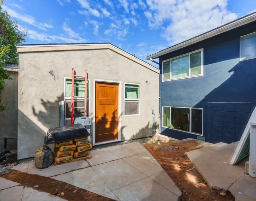 Weighing the Pros and Cons of DIY ADU Construction with a partially framed accessory dwelling unit on a residential lot