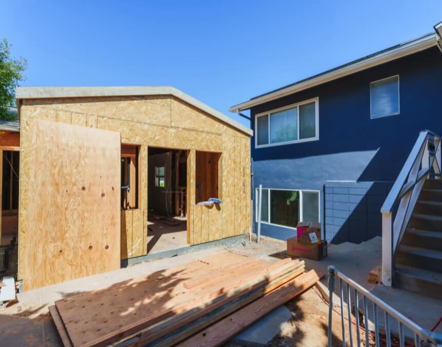 What Are the Cheapest or Lowest-Interest ADU Loan Options – compact backyard ADU build in progress next to a primary residence.