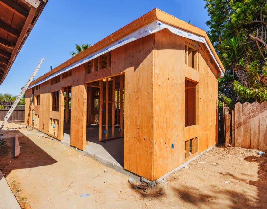 Using Professionals and Navigating Permits ADU construction framing stage showing structural build process